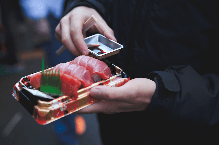 Person holding Sushi